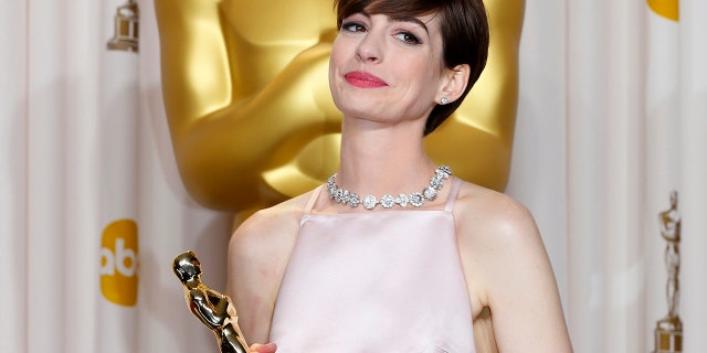 Anne Hathaway, winner of Best Supporting Actress for her role in 'Les Miserables', poses with her Oscar at the 85th Academy Awards in Hollywood, California on February 24, 2013.