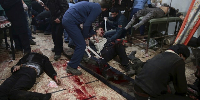 Medics treat injured people inside a field hospital after air and missile strikes in the Douma neighborhood of Damascus, Syria, in 2015. The injured are taken to basements and shelters transformed into field hospitals run by medical staff who have stayed in the battered neighborhood of Damascus.