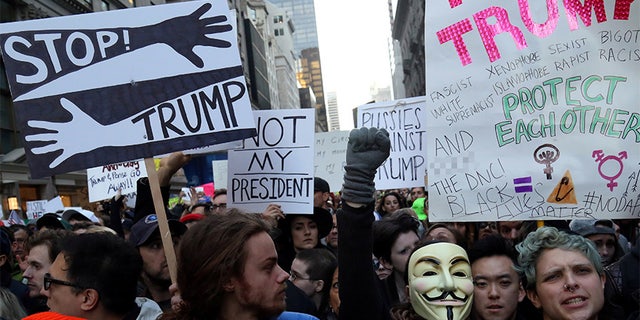 Demonstrators chant slogans during a protest against President-elect Donald Trump in Manhattan, New York, on November 12, 2016.