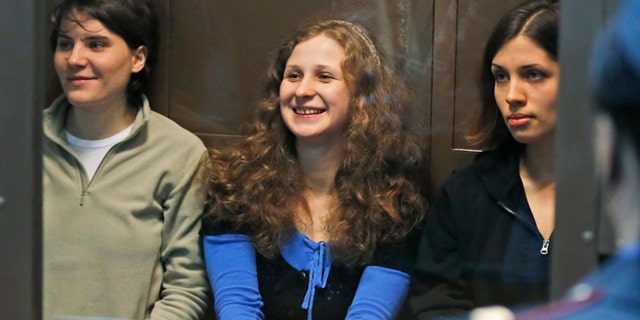 Oct. 10, 2012: In this file photo, feminist punk group Pussy Riot members, from left, Yekaterina Samutsevich, Maria Alekhina and Nadezhda Tolokonnikova sit in a glass cage at a court room in Moscow, Russia.