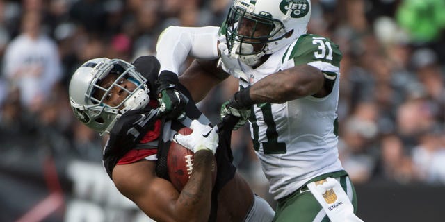 November 1, 2015; Oakland, CA, USA; New York Jets cornerback Antonio Cromartie (31) tackles Oakland Raiders wide receiver Michael Crabtree (15) during the second quarter at O.co Coliseum.