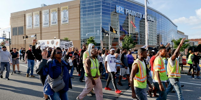 Marchers walk by PPG Paints arena as they protest the shooting death of Antwon Rose Jr. on Tuesday, June 26, 2018, in Pittsburgh