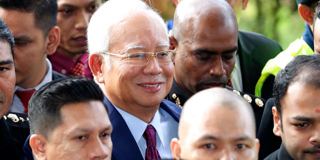 Former Malaysian Prime Minister Najib Razak, center, arrives at a court house in Kuala Lumpur, Malaysia.