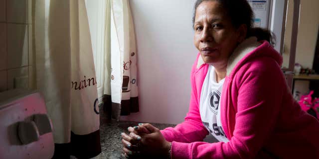 In this photo taken March 24, 2016, Sharon Johnson poses in her apartment in Lynn, Mass. Johnson calls herself an addict, although shes been sober for three years now. She started by smoking pot and eventually moved to crack cocaine. Her daughter has tried heroin and I believe Im going to pull her out of the gutter someday, she laments. (AP Photo/Michael Dwyer)