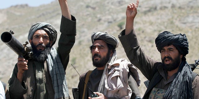 Taliban fighters react 2016 to a speech by their senior leader in the Shindand district of Herat province, Afghanistan.