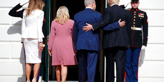 President Donald Trump, first lady Melania Trump, Israeli Prime Minister Benjamin Netanyahu and his wife Sara walk into the White House in Washington.