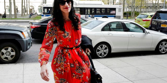 FILE - In this Nov. 2, 2016 file photo, Huma Abedin is seen in the Brooklyn borough of New York. A person familiar with the investigation into Hillary Clinton's use of a private email server says Abedin did not forward "hundreds and thousands" of emails to her husband's laptop, as FBI Director James Comey testified to Congress. (AP Photo/Mark Lennihan, File)