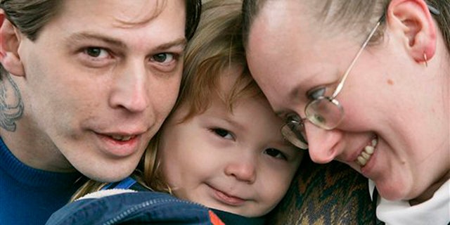 FILE - This Tuesday, Dec. 16, 2008 file photo, shows Isidore Heath Campbell, left, his wife, Deborah, and son Adolf Hitler Campbell, 3, in Easton, Pa. On Monday, May 8, 2017, Isidore Heath Campbell officially became Isidore Heath Hitler. He first gained national attention when a supermarket refused to decorate a birthday cake for his son, Adolf Hitler. (AP Photo/Rich Schultz, File)
