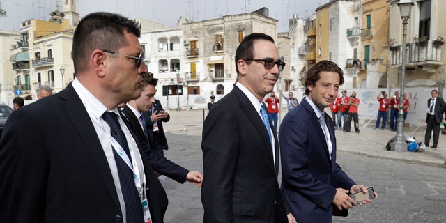 United States Treasury Secretary Steven Mnuchin, center, leaves at the end of a plenary session during a G7 of Finance Ministers and Central Bank Governors meeting, in Bari, southern Italy, Friday, May 12, 2017. (AP Photo/Andrew Medichini)