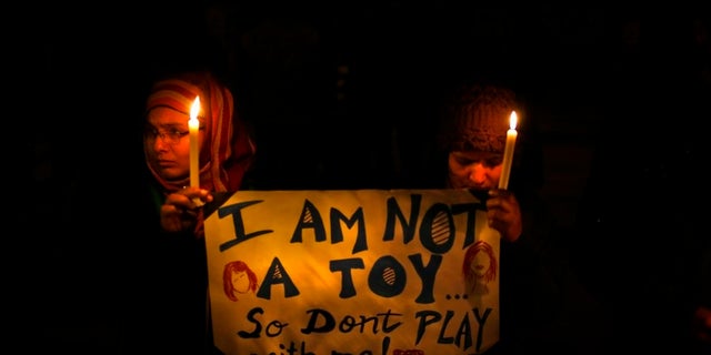 People in India hold a candlelight vigil in New Delhi to mourn the death of a gang rape victim in December 2012.