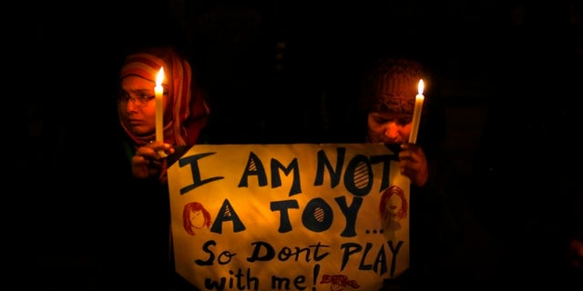 People in India hold a candlelight vigil in New Delhi to mourn the death of a gang rape victim in December 2012.