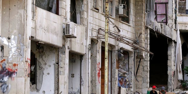 FILE -- Children sit outside their damaged house at the mountain resort town of Zabadani in the Damascus countryside, Syria, Thursday, May 18, 2017. A U.S. airstrike struck pro-Syrian government forces for the first time, hitting a convoy in the desert near the border with Jordan, U.S. officials and Syrian activists said, an apparent signal to President Bashar Assad to keep his forces out of a zone where U.S.-backed rebels are fighting the Islamic State group.