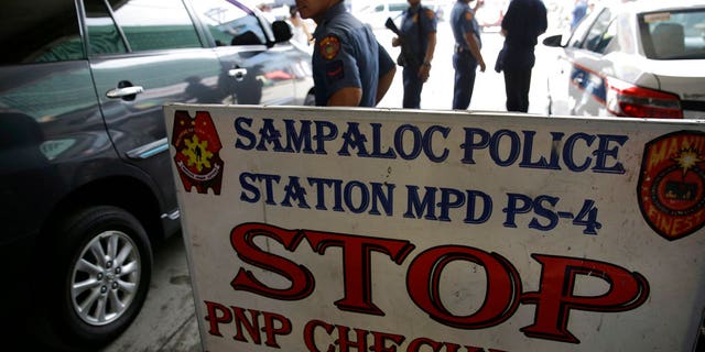 Policemen watches vehicles at a checkpoint in Manila, Philippines, Wednesday, May 24, 2017 as the Philippine National Police is placed under full alert status following the declaration of martial law in Mindanao southern Philippines. (Associated Press)