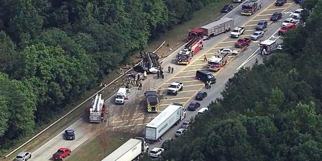 In this image made from video by WSB-TV Atlanta, authorities render assistance to injured people on an overturned church bus, Thursday, June 8, 2017, in Atlanta. Mount Zion Baptist Church in Huntsville, Ala., posted on its Facebook page that one of its buses with its student ministry mission was involved in a crash while traveling to the airport. (WSB-TV via AP)