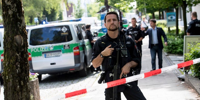 Police block a street near a subway station in Munich, Germany, Tuesday, June 13, 2017.  Several people were injured, including a police officer, in a shooting early Tuesday at a Munich subway station, police said. Munich police said in a tweet that the policewoman's injuries were serious. The suspect was also injured and is in custody. The shooting occurred during a morning police check at the Unterfoehring subway station, Munich police spokesman Michael Riehlein said. (Sven Hoppe/dpa via AP)