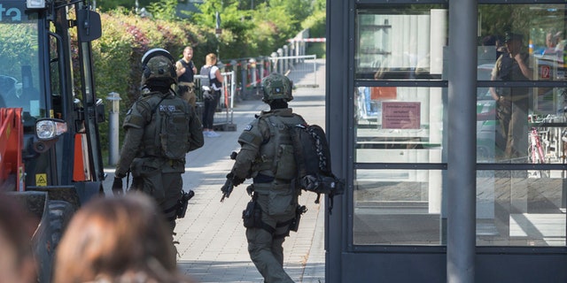Special police guard outside a subway station in Munich, Germany, Tuesday, June 13, 2017. Several people were injured, including a police officer, in a shooting early Tuesday at a Munich subway station, police said. Munich police said in a tweet that the policewoman's injuries were serious. The suspect was also injured and is in custody. The shooting occurred during a morning police check at the Unterfoehring subway station, Munich police spokesman Michael Riehlein said. (Andreas Prott/dpa via AP)
