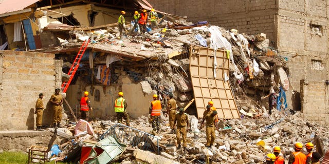 Rescuers work at the site of a building collapse in Nairobi, Kenya Tuesday, June 13, 2017. Nairobi Police Chief Japheth Koome said Tuesday that at least 10 people had been reported missing after the collapse Monday night. (AP Photo/Khalil Senosi)