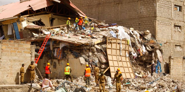 Rescuers work at the site of a building collapse in Nairobi, Kenya Tuesday, June 13, 2017. Nairobi Police Chief Japheth Koome said Tuesday that at least 10 people had been reported missing after the collapse Monday night. (AP Photo/Khalil Senosi)