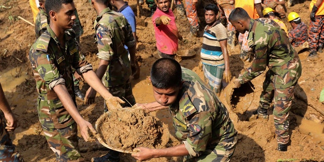 Rescuers search for survivors and bodies after Tuesday's massive landslide in Rangamati district, Bangladesh, Wednesday, June 14, 2017. Rescuers struggled on Wednesday to reach villages hit by massive landslides that have killed more than a hundred while also burying roads and cutting power in southeastern Bangladesh, officials said. (AP Photo)