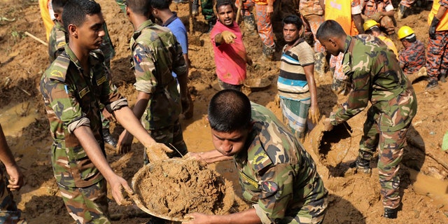 Rescuers search for survivors and bodies after Tuesday's massive landslide in Rangamati district, Bangladesh, Wednesday, June 14, 2017. Rescuers struggled on Wednesday to reach villages hit by massive landslides that have killed more than a hundred while also burying roads and cutting power in southeastern Bangladesh, officials said. (AP Photo)
