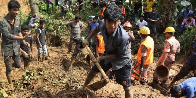 Rescuers search for survivors and bodies after Tuesday's massive landslide in Rangamati district, Bangladesh, Wednesday, June 14, 2017. Rescuers struggled on Wednesday to reach villages hit by massive landslides that have killed more than a hundred while also burying roads and cutting power in southeastern Bangladesh, officials said. (AP Photo)