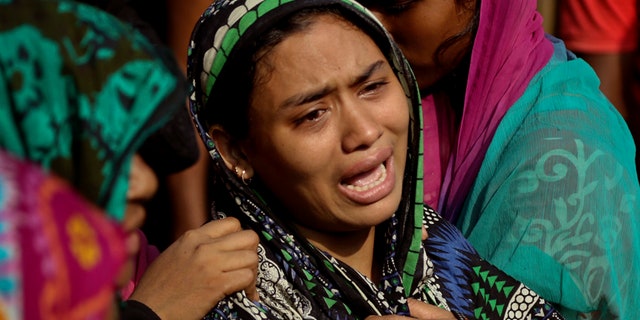 A Bangladeshi woman cries after her relative's body was recovered after Tuesday's massive landslide in Rangamati district, Bangladesh, Wednesday, June 14, 2017. Rescuers struggled on Wednesday to reach villages hit by massive landslides that have killed more than a hundred while also burying roads and cutting power in southeastern Bangladesh, officials said. (AP Photo)