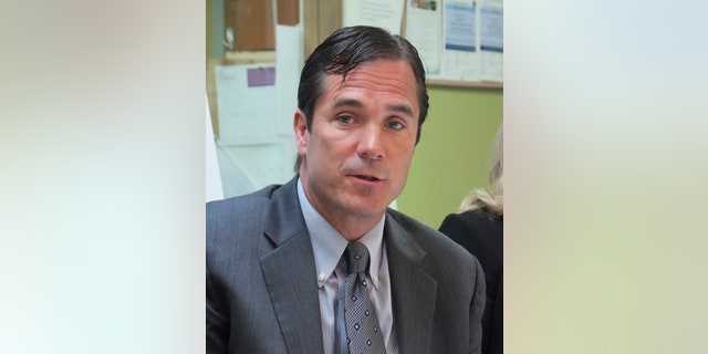 In this June 5, 2017 photo, Nick Lyon, Michigan Health and Human Services Director, speaks in support of the state's Medicaid expansion program in Lansing, Mich. Lyon was charged Wednesday, June 14, 2017, with involuntary manslaughter in a criminal investigation of Flint's lead-contaminated water. (AP Photo/David Eggert)