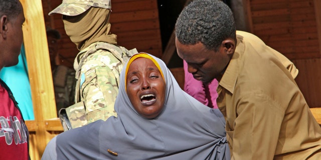 A mother whose daughter was shot in the head by attackers during a militant attack on a restaurant, grieves in Mogadishu, Somalia Thursday, June 15, 2017.