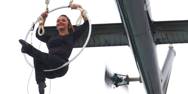 Erendira Wallenda performs a series of acrobatic maneuvers, including hanging by her teeth, while suspended from a helicopter above Niagara Falls in Niagara Falls, N.Y. Thursday June 15, 2017. (AP Photo/Bill Wippert)