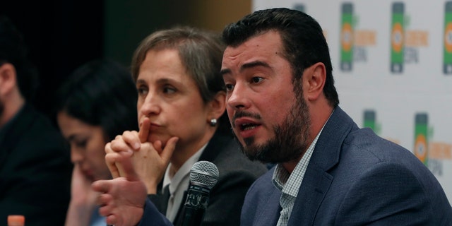 Mario Patron Sanchez, director of the Miguel Agustín Pro Juárez Center for Human Rights, talks during a news conference, seated next to Mexican journalist Carmen Aristegui, in Mexico City on Monday.