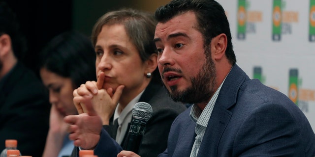 Mario Patron Sanchez, director of the Miguel Agustín Pro Juárez Center for Human Rights, talks during a news conference, seated next to Mexican journalist Carmen Aristegui, in Mexico City on Monday.
