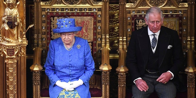 Britain's Queen Elizabeth II and Prince Charles sit in the House of Lords at the official State Opening of Parliament in London, Wednesday, June 21, 2017. 