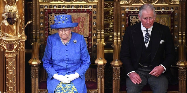 Britain's Queen Elizabeth II and Prince Charles sit in the House of Lords at the official State Opening of Parliament in London, Wednesday, June 21, 2017. Queen Elizabeth II goes to parliament Wednesday to outline the government's legislative program with far less pageantry than usual in a speech expected to be dominated by Britain's plans for leaving the European Union. (Carl Court/Pool via AP)