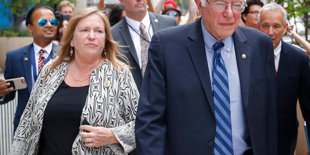 FILE--In this July 28, 2016 file photo, Sen. Bernie Sanders, I-Vt. and his wife Jane walk through downtown in Philadelphia during the final day of the Democratic National Convention. Sanders and his wife Jane O'Meara Sanders have hired lawyers in the face of federal investigations into the finances of the now-defunct Burlington College, which closed last year due, many feel, to debts incurred when Jane Sanders entered into an ill-advised real estate deal. (AP Photo/John Minchillo, File)