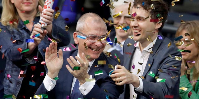Green Party's gay rights activist Volker Beck, center, and fellow faction members celebrate with a confetti popper after German Federal Parliament, Bundestag, voted to legalize same-sex marriage in Berlin, Germany, Friday, June 30, 2017. (AP Photo/Michael Sohn)