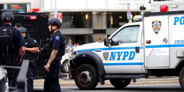 Police gather outside Bronx Lebanon Hospital in New York after a gunman opened fire and then took his own life there on Friday, June 30, 2017. The gunman, identified as Dr. Henry Bello who used to work at the hospital, returned with a rifle hidden under his white lab coat, law enforcement officials said. (AP Photo/Mary Altaffer)