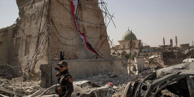 An Iraqi Special Forces soldier walks in the destroyed al-Nuri mosque complex as Iraqi forces continue their advance against Islamic State militants in the Old City of Mosul, Iraq, Sunday, July 2, 2017. (AP Photo/Felipe Dana)