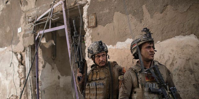 Iraqi Special Forces soldiers gather before advancing against Islamic State militants in the Old City of Mosul, Iraq, Sunday, July 2, 2017. (AP Photo/Felipe Dana)