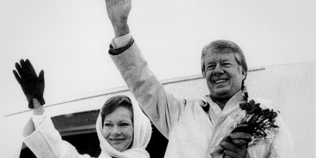 FILE - In this Dec. 31,1977, file picture, President Jimmy Carter and his wife Rosalynn Carter wave goodbye before their departure from Warsaw, Poland, first stop of their trip through seven countries. When President Donald Trump arrives in Warsaw, on Wednesday, July 5, 2017, with his wife Melania, he will be the eight U.S. president to visit Poland, a Central European nation that peacefully shed Moscow's dominance in 1989, joined NATO in 1999 and the European Union in 2004, and which is one of the staunchest U.S. allies in Europe. (AP Photo, File)