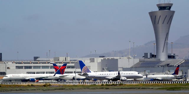 July 11, 2017: Departing and parked aircraft intersect at San Francisco International Airport.