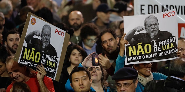 Demonstrators hold signs that read in Portuguese "No Prison for Lula," during a protest against the decision by Judge Sergio Moro to convict former Brazilian President Luiz Inacio Lula da Silva in Sao Paulo, Brazil, Wednesday, July 12, 2017. Lula da Silva was found guilty of corruption and money laundering and sentenced to almost 10 years in prison. (AP Photo/Andre Penner)