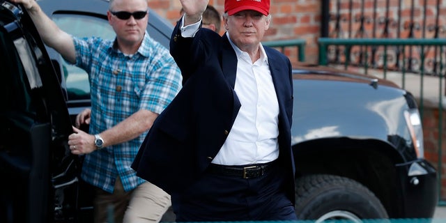 President Donald Trump arrives to enter his presidential viewing stand Saturday, July 15, 2017, during the U.S. Women's Open Golf tournament at Trump National Golf Club in Bedminster, N.J.