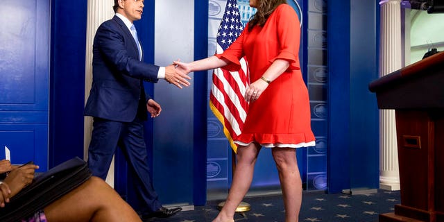 Anthony Scaramucci, incoming White House communications director, shakes hands with the White House press secretary Sarah Huckabee Sanders as he takes the podium at the daily press briefing at the White House, Friday, July 21, 2017, in Washington. White House press secretary Sean Spicer resigned earlier in the day. (AP Photo/Andrew Harnik)