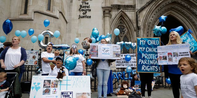Supporters of critically ill baby Charlie Gard shout and hold placards.
