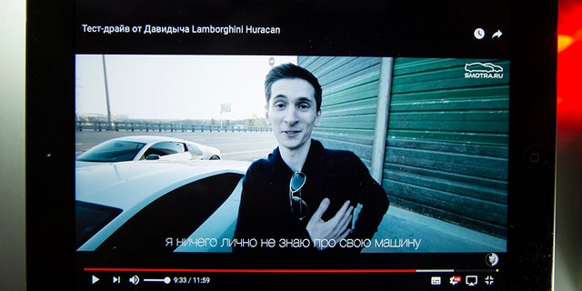 A tablet shows archive Youtube footage dated Monday, Aug. 2, 2015 featuring Yevgeny Nikulin after a Lamborghini Huracan race outside Moscow, Russia.