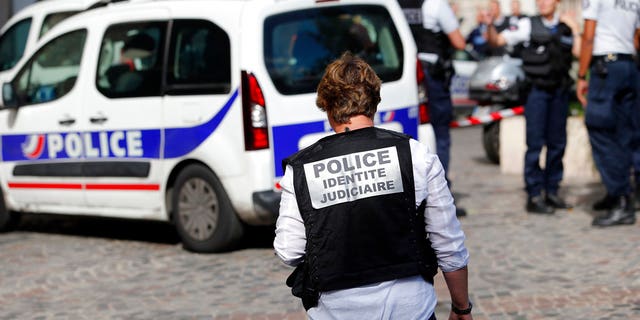 French police work on the scene of an attack that injured six soldiers.
