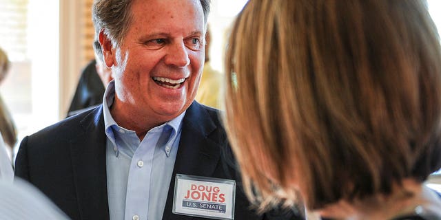 Senate candidate Doug Jones chats with constituents before a forum in Decatur, Ala.