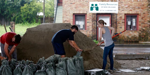 New Orleans residents fill more sandbags for potential more flooding from rain storms on Aug. 11.