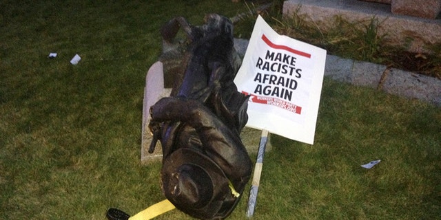 A toppled Confederate statue lies on the ground on Monday, Aug. 14, 2017, in Durham, N.C.