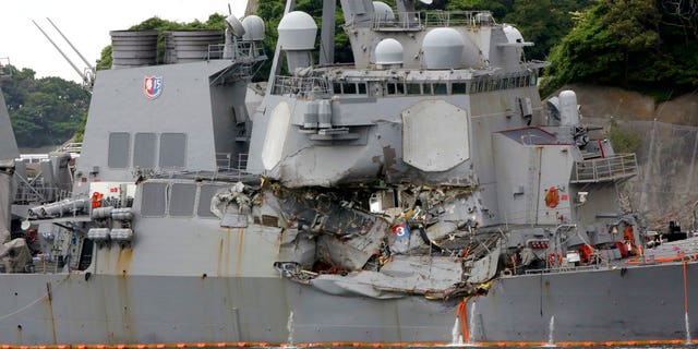 In this June 18, 2017, photo, damaged USS Fitzgerald is docked at the U.S. Naval base in Yokosuka, southwest of Tokyo, after colliding with Philippine-flagged container ship ACX Crystal off Japan.